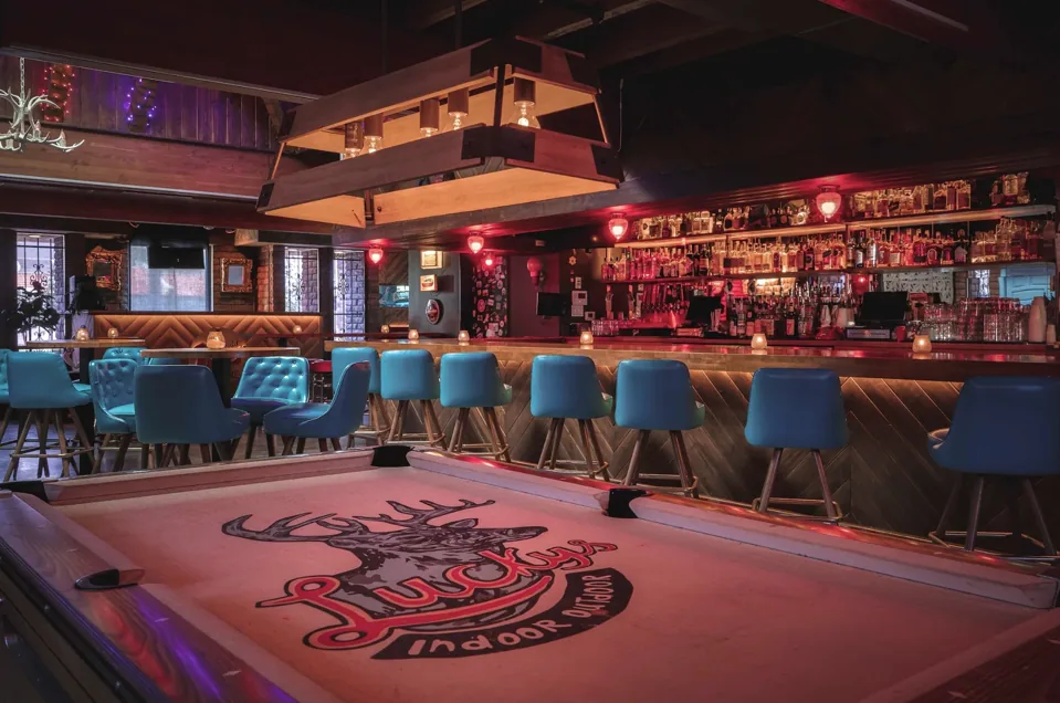Lucky’s bar and shuffleboard table with its logo